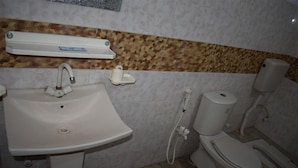 A bathroom with a white sink, toilet, and bidet. - Royal Inn Guest House (Mekhtar)