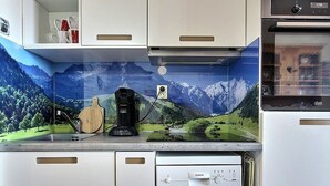 A kitchen with a coffee maker, a toaster, and a dishwasher. - Studio cabin for 4 on slopes with balcony (Belle Plagne)