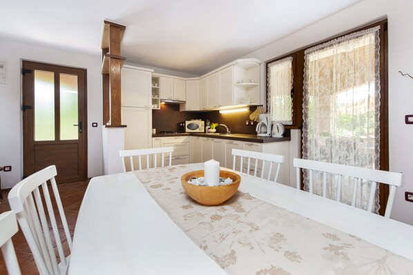 Enjoy cooking and dining in this well-equipped kitchen with appliances and a central island.