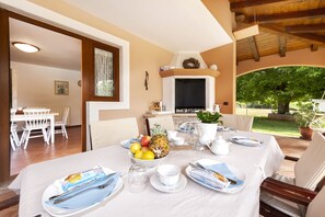 Enjoy a meal in this inviting dining area with a garden view.