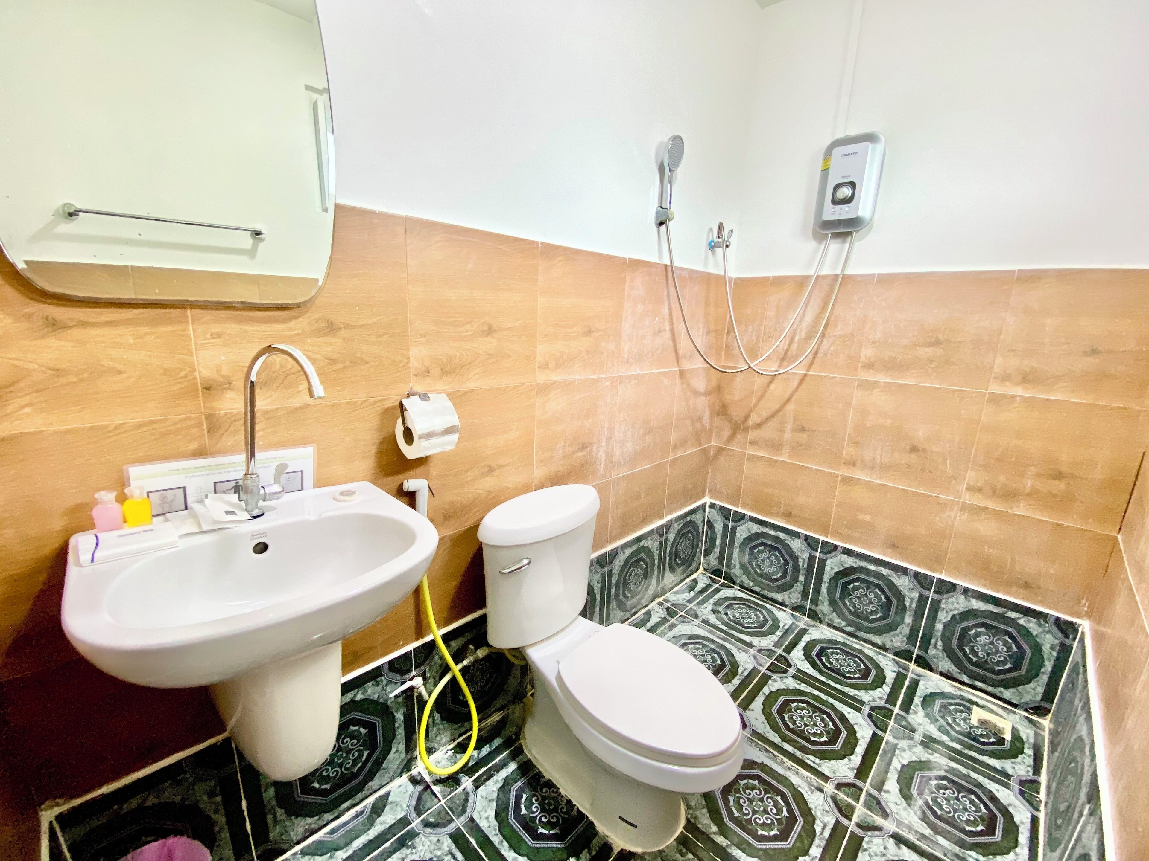 A bathroom with a sink, toilet, and shower.