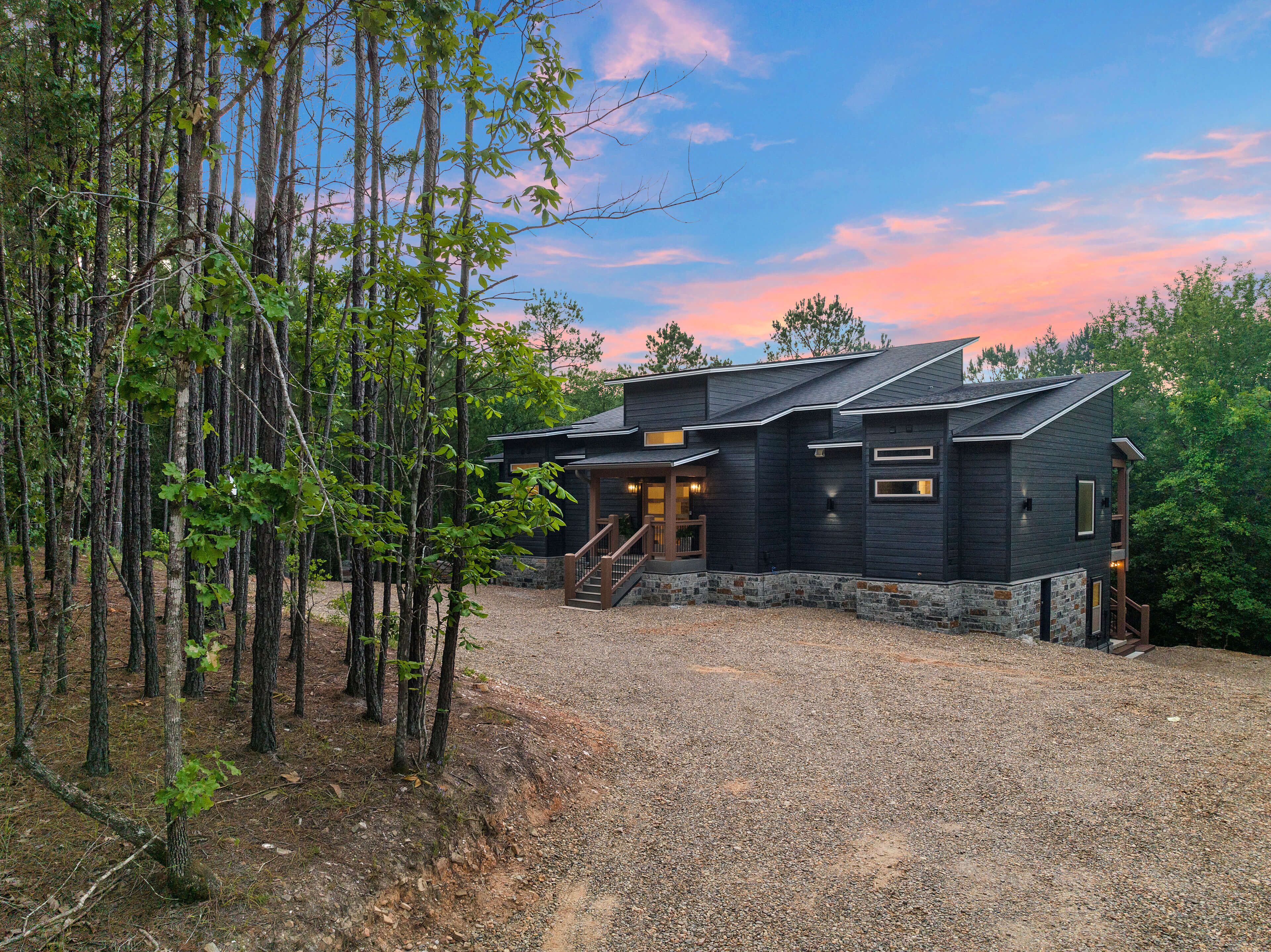 A private, bright, modern rustic cabin – surrounded by trees.