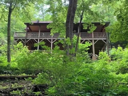 Spacious suite surrounded by nature with living room, fireplace, porch, fire pit
