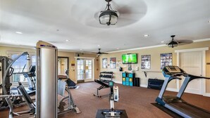 A gym with treadmills, weight machines, and a television. - Welcome to La Vista! (St. George Island)