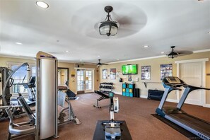 A gym with treadmills, weight machines, and a television. - Welcome to La Vista! (St. George Island)