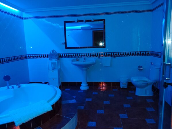 A bathroom with a bathtub, sink, and toilet.