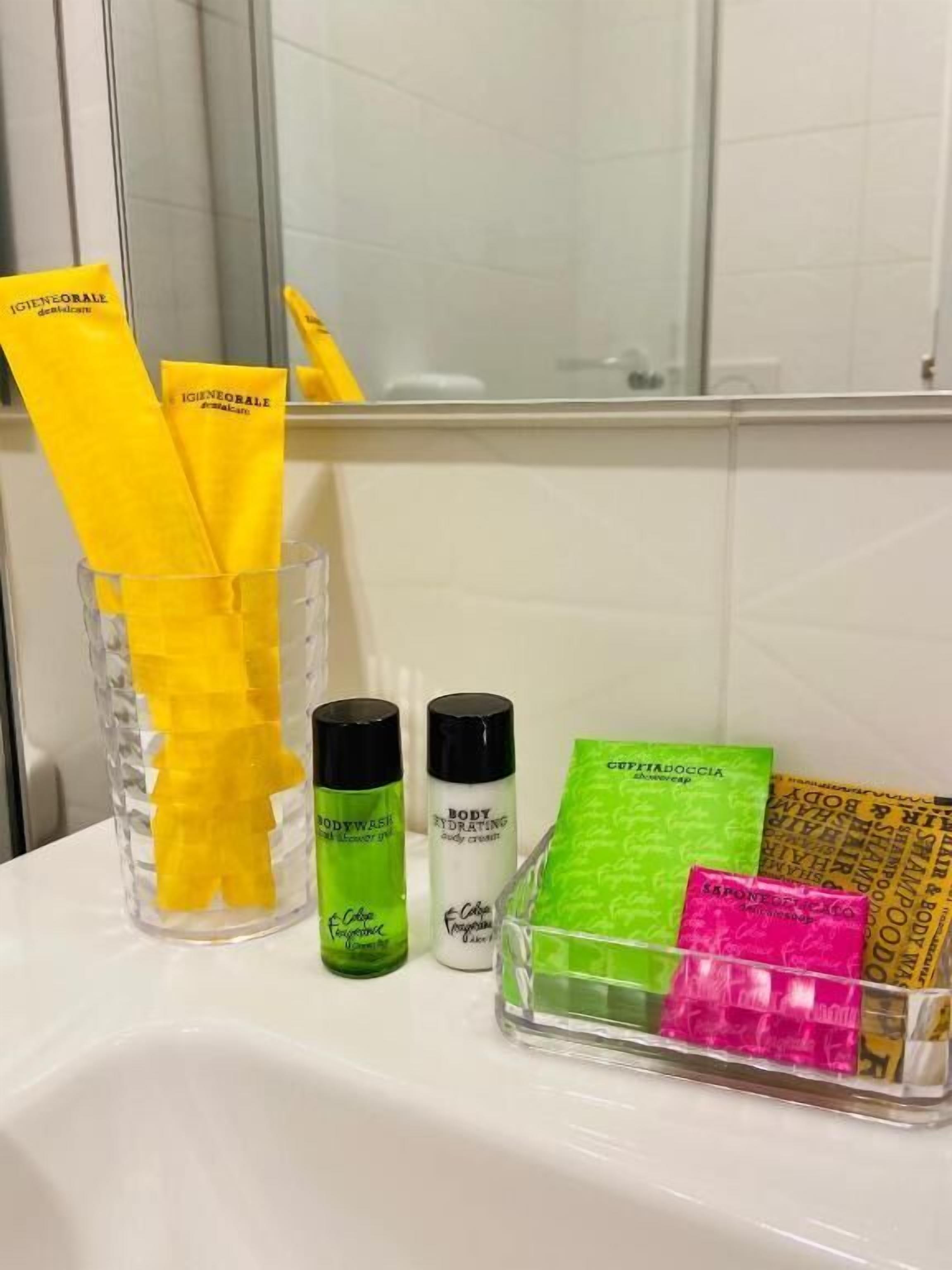 A bathroom with toiletries including body wash, body lotion, and shampoo.