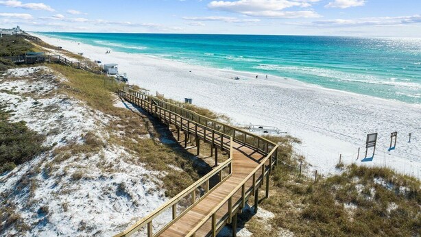 A beach with a wooden boardwalk leading to the shore, clear turquoise water, and a clear sky. - Private Pool,LSV/Golf Cart, & 6 Bikes! Steps to Seaside in the Heart of Old Seagrove! (Santa Rosa Beach)