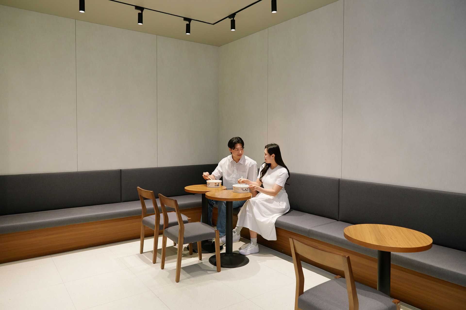 A modern interior with a seating area, tables, and a bench.