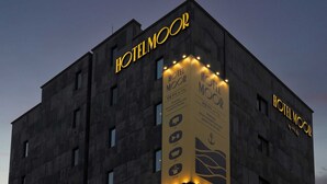 A building with the sign "HOTEL MOOR" and a vertical banner with icons for movie, spa, and stylist services. - Moor Hotel by Anook Mokpo (Mokpo)