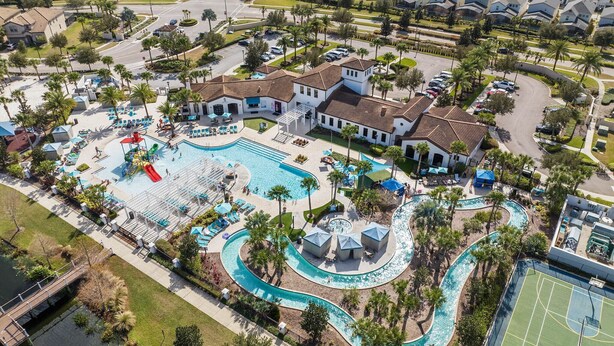 An aerial view of a residential area with a large swimming pool, multiple tennis courts, and a clubhouse. - 8BR Villa! Free Arcade, Pool, Spa Windsor Westside (Kissimmee)