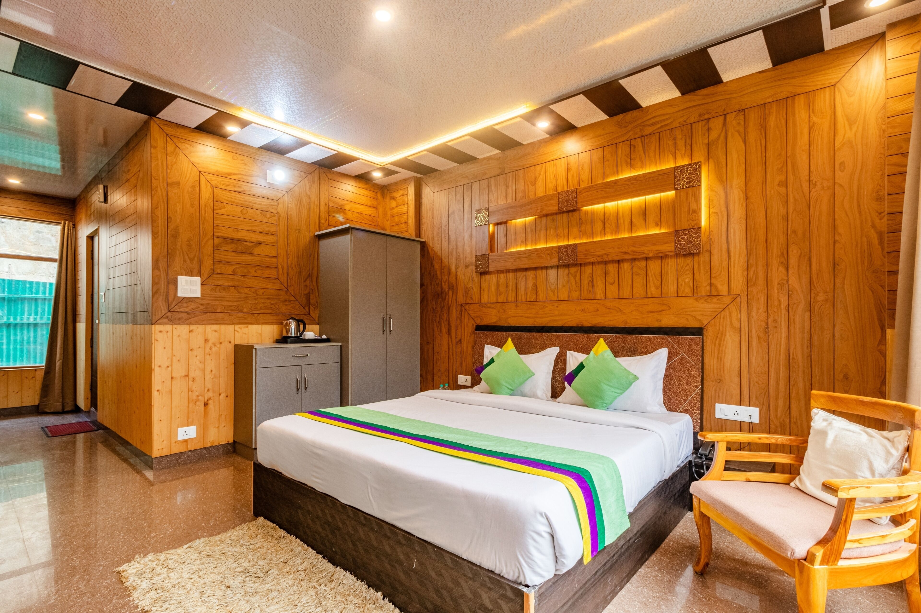 A wooden-themed bedroom with a bed, a chair, and a wardrobe.