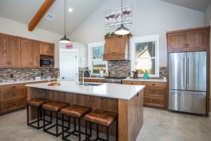 Enjoy cooking in this well-equipped kitchen with a central island and appliances.