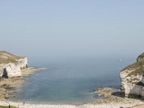 A coastal scene with cliffs and a beach.