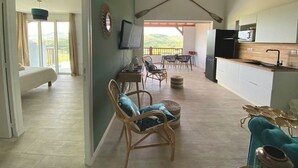 A spacious living area with a balcony, a kitchen, and a dining area. - Bwa Flote' (Les Trois-Îlets)