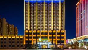 A Holiday Inn Express building with a prominent sign, multiple floors, and a well-lit facade. - Holiday Inn Express Xinji City Center by IHG (Shijiazhuang)