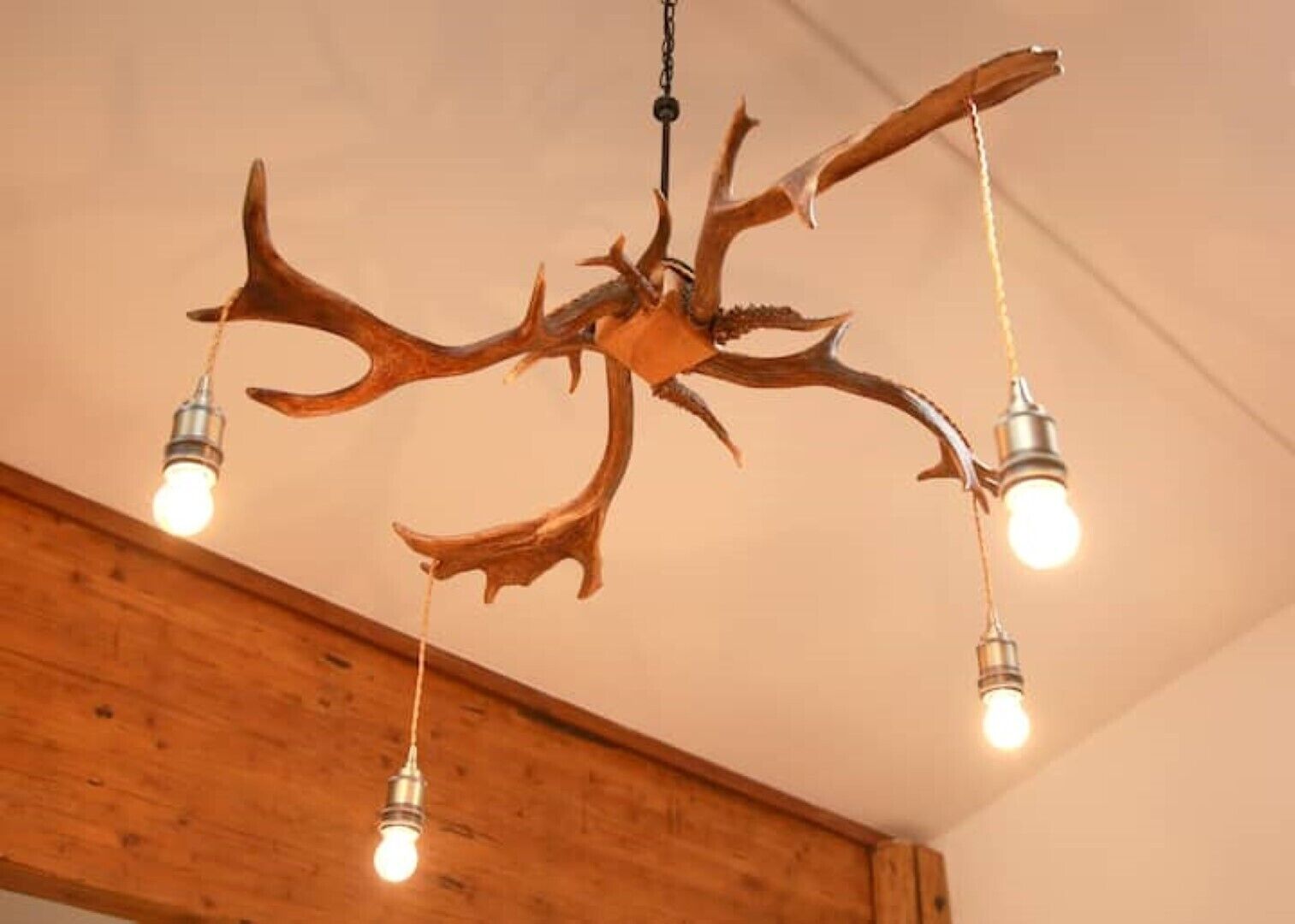 A chandelier with antlers as the central design element, suspended from the ceiling.