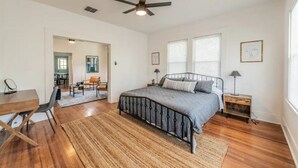 A bedroom with a bed, a desk, a chair, a ceiling fan, and a window. - Private Deck & Patio with Parking- 3blks to Pearl food & fun! (San Antonio)