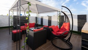 An outdoor patio with wicker furniture, a hanging chair, and a canopy. - Maryline's waterfall with Piscine & Rooftop (Casablanca)