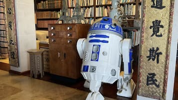 Step into the serene library, home to a unique R2-D2 model and a vast collection of books.