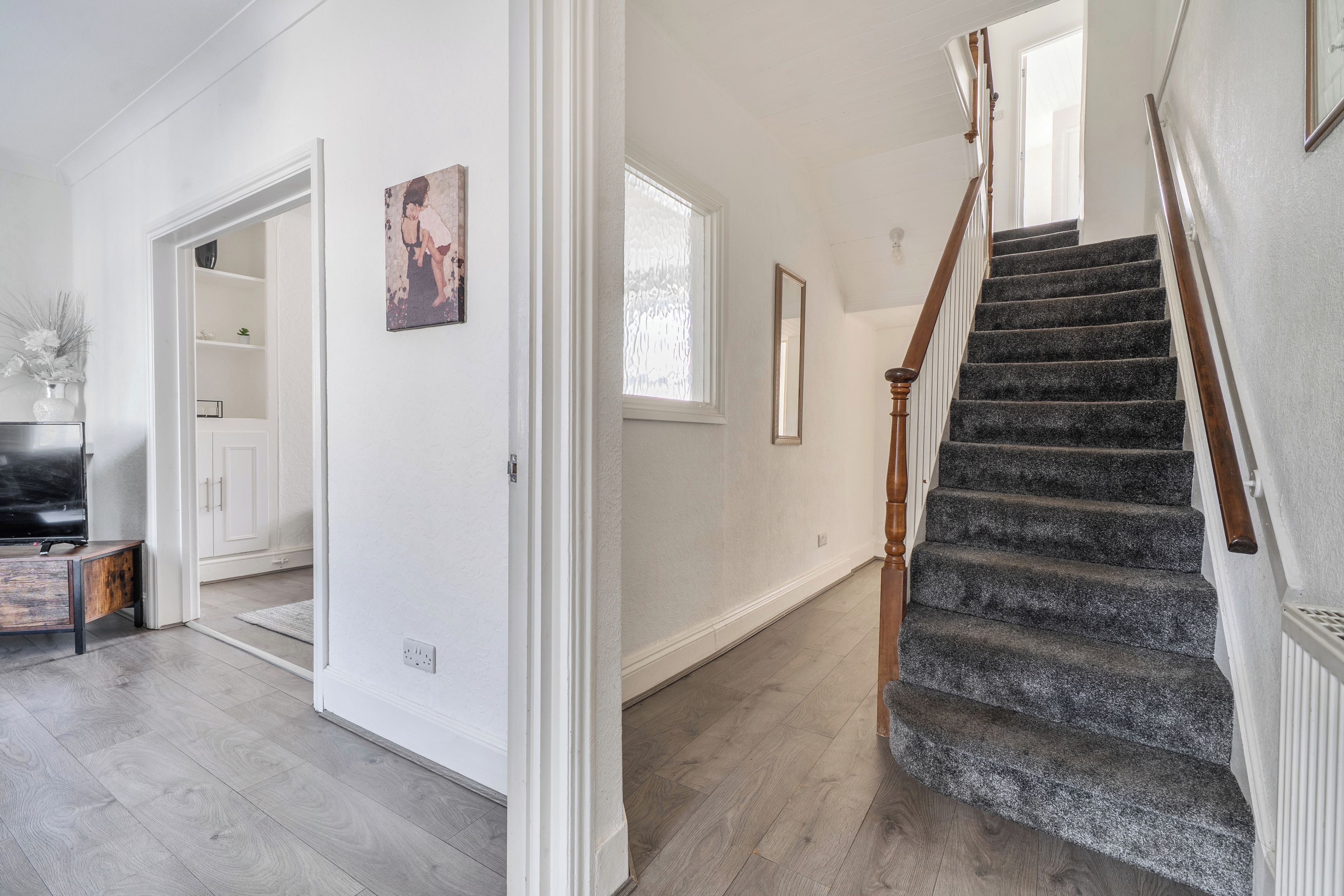 A staircase with wooden handrails leading to a landing.