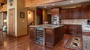 A spacious kitchen with wooden cabinets, a built-in oven, and a granite countertop.