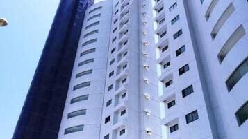 A high-rise building with multiple floors and balconies.