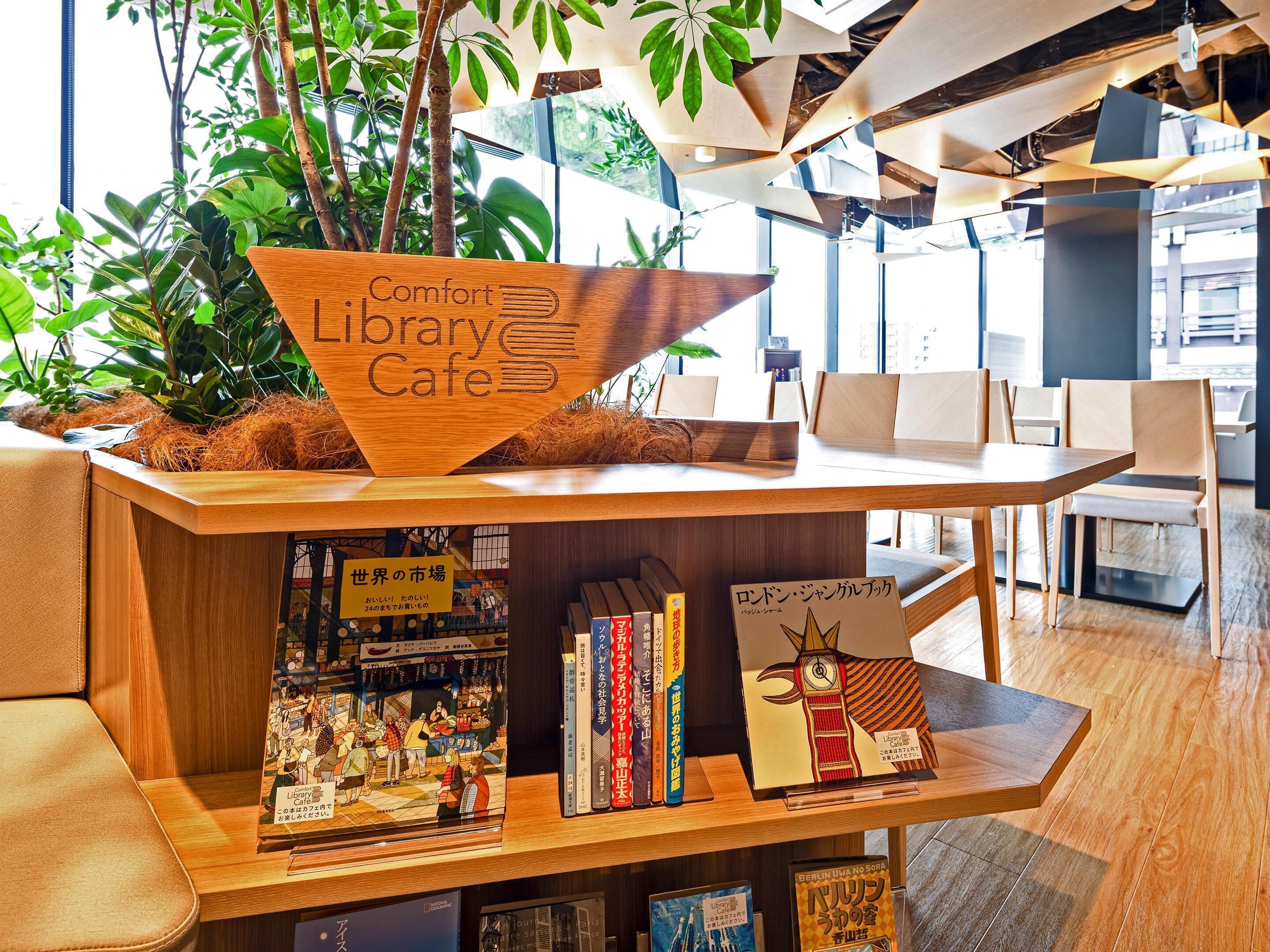 Un café biblioteca con muebles de madera, estanterías y plantas de interior.