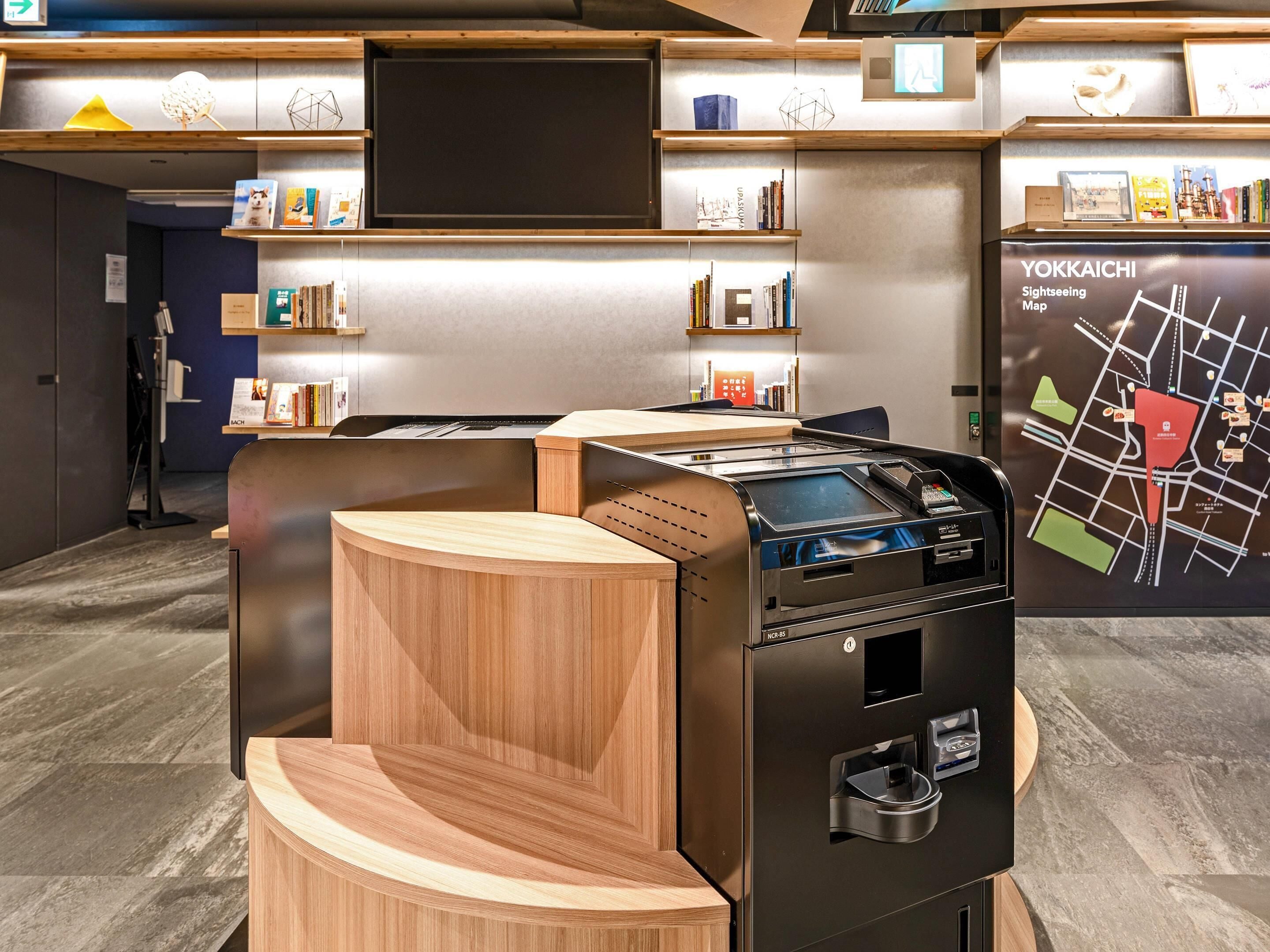 A modern, well-lit room with a large map on the wall, a wooden counter, and a vending machine.
