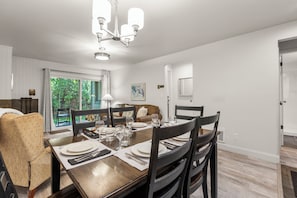 A dining room with a wooden table set for four, surrounded by dark wooden chairs. - Managed by Park City Lodging-True Ski-In/Ski-Out to Park City Mountain Resort! (Park City)