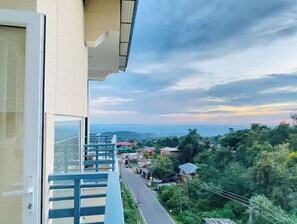 Enjoy an outdoor space with a view of the lush landscape and distant town.
