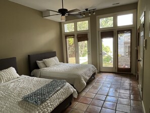 A bedroom with two beds, a ceiling fan, and large windows with blinds. - Spacious 5-Bedroom Waterfront Oasis with Private Dock, Pool and Hot Tub (Tracys Landing)