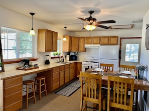 Enjoy cooking in this well-equipped kitchen with a central island, dining table, and modern appliances.