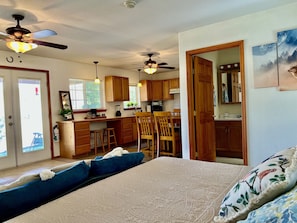 Relax in this spacious living area with a large bed, dining table, and kitchenette.