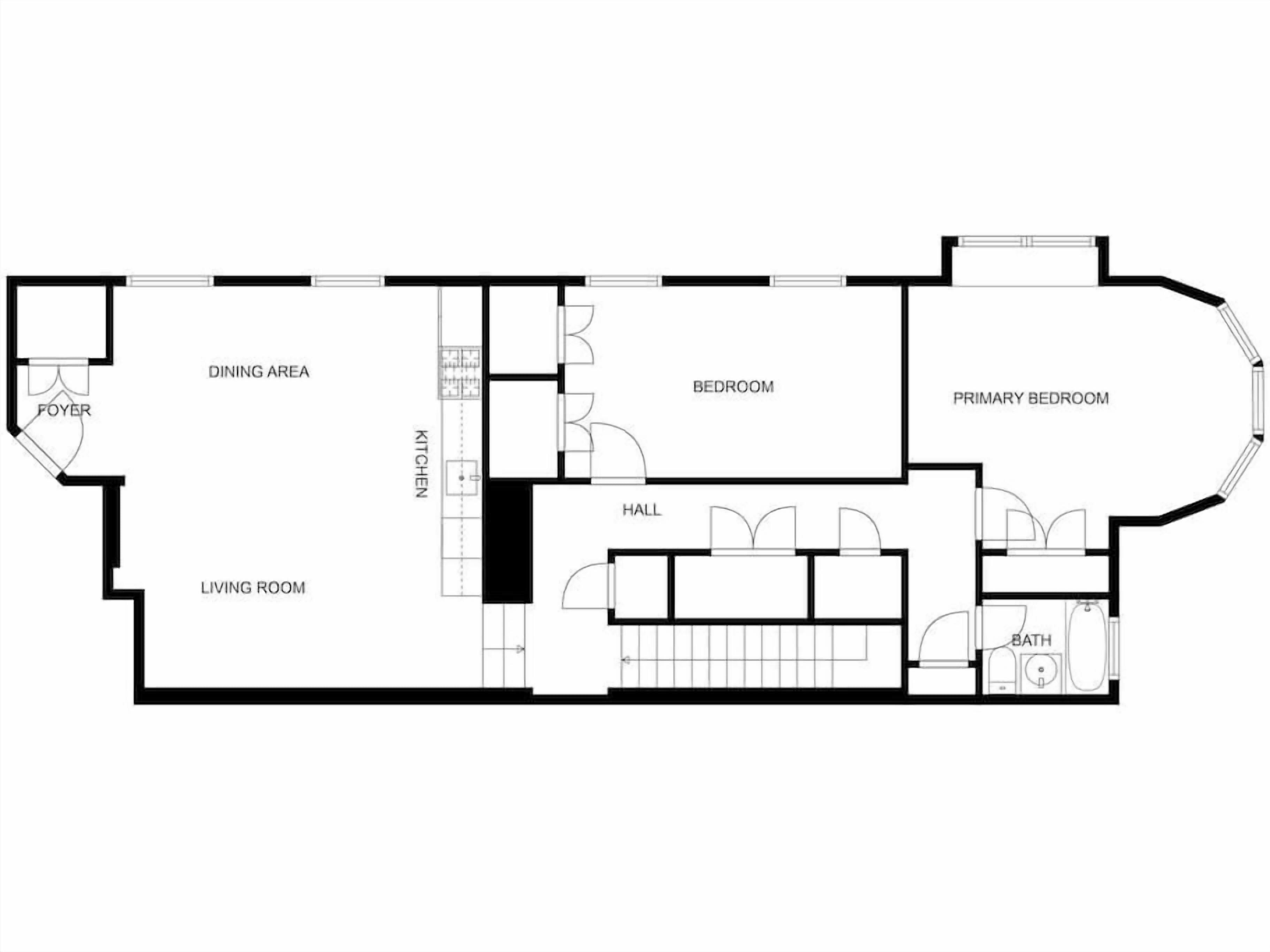 Un plan d’étage illustrant l’aménagement d’une chambre d’hôtel, comprenant un coin repas, un hall d’entrée, un salon, une cuisine, un couloir, la chambre principale et une salle de bain.
