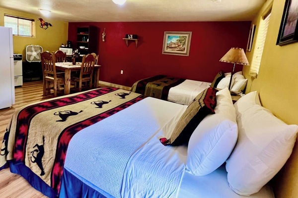 Two queen beds, dining table, full kitchen