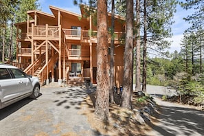 Step up to the cabin's entrance, where a set of stairs leads to a cozy retreat.