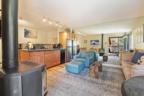 Cozy living space with a modern kitchen, comfortable seating area, and fireplace.