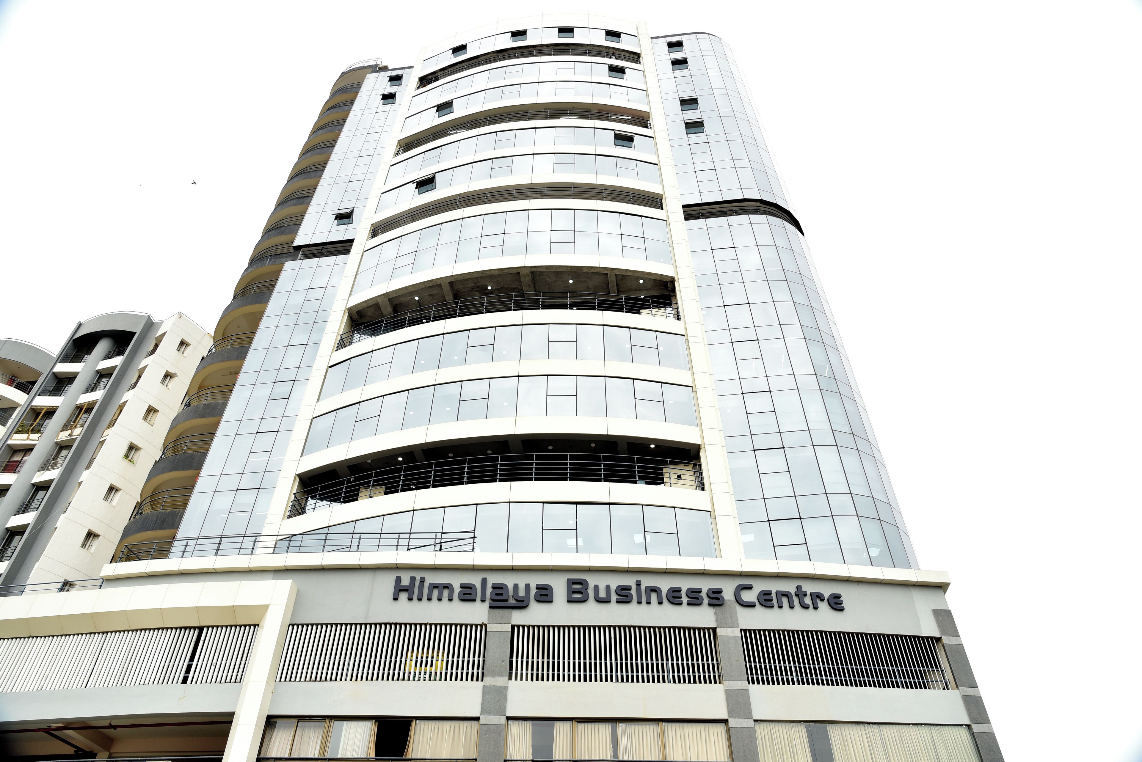 A tall, modern building with the sign "Himalaya Business Centre" at the bottom.