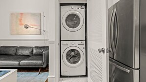 A compact living space with a washing machine and a refrigerator. - Luxury 1BD Rittenhouse Sq. | Hosted By Stay Rafa (Philadelphia)