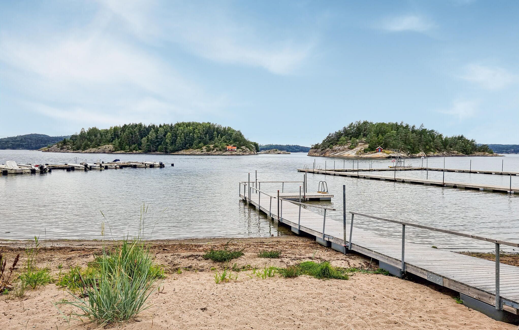 A calm lake with multiple docks extending into the water.