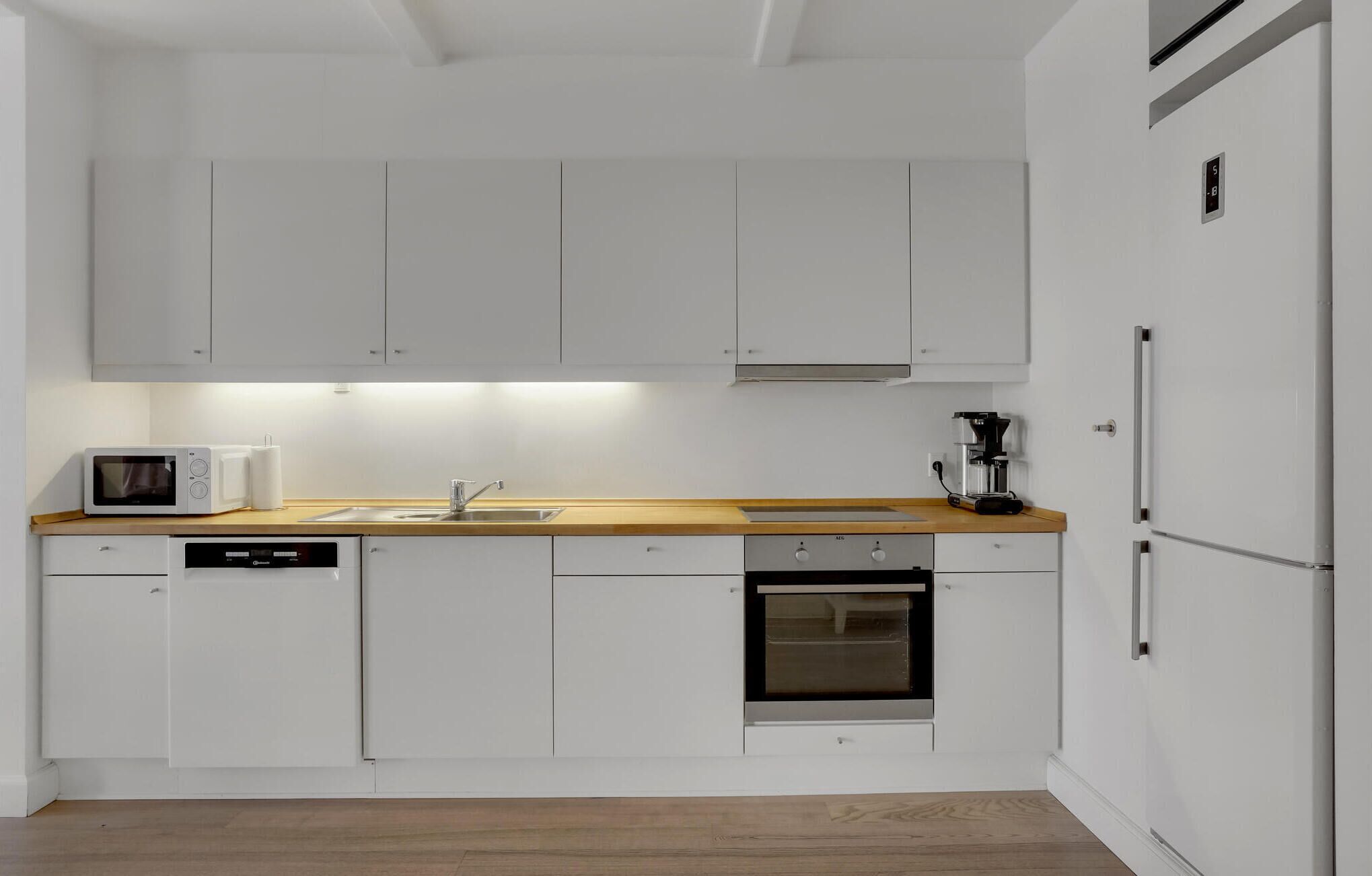 Fridge, stovetop, dishwasher, coffee/tea maker