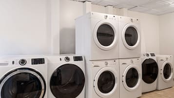 Laundry room with front-loading and stacked washers and dryers.