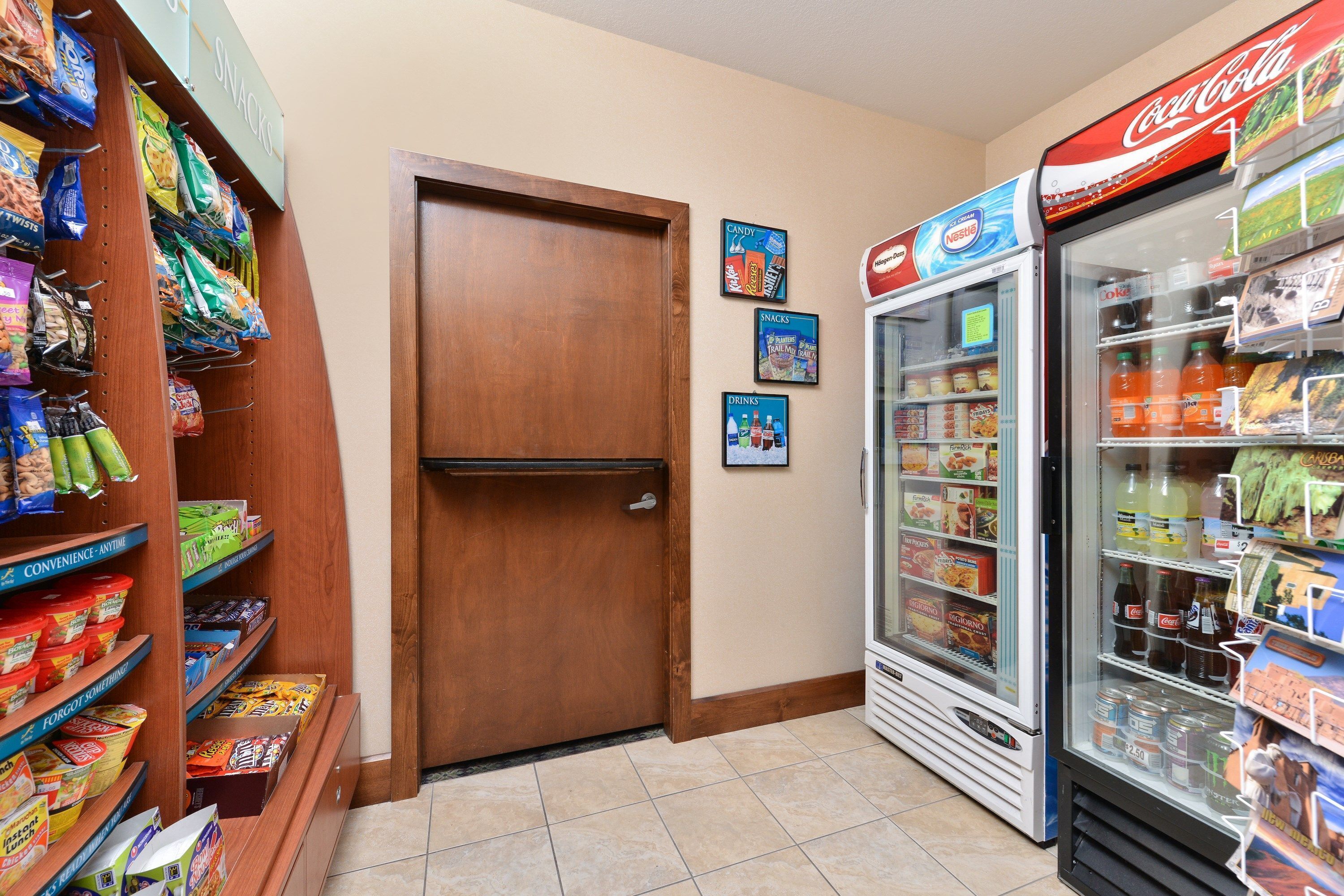 A snack and drink vending area with a refrigerator stocked with beverages and snacks.