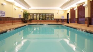 A large indoor pool with clear water, marked depth lines, and safety signs. - King Studio | Less than 1 Mile from USC (Columbia)