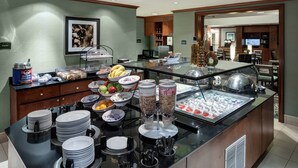 A buffet with various food items, including fruits, cereals, and beverages. - 1 Bedroom Suite | Outdoor Pool, Free Breakfast (Ridgeland)