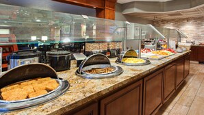 A buffet setup with various food items and kitchen equipment. - Free Breakfast. Outdoor Pool & Hot Tub (Lake Forest)