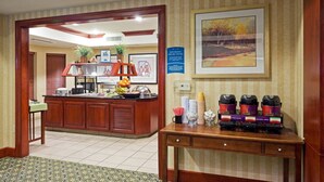 A hotel lobby with a reception desk, a buffet area, and a coffee station. - Studio w/ Kitchen | Free Breakfast Buffet (Cranbury)