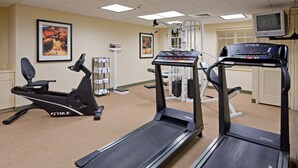 A fitness center with treadmills, a stationary bike, and weight machines. - Studio w/ Kitchen | Free Breakfast Buffet (Cranbury)