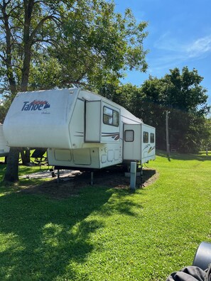 Park your home away from home in this well-maintained RV, featuring a spacious interior and a convenient door.